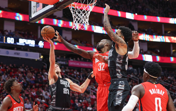 Rockets forward Jabari Smith Jr. and San Antonio Spurs forward Keldon Johnson (3) attempt to get a loose ball during the fourth quarter at Toyota Center.